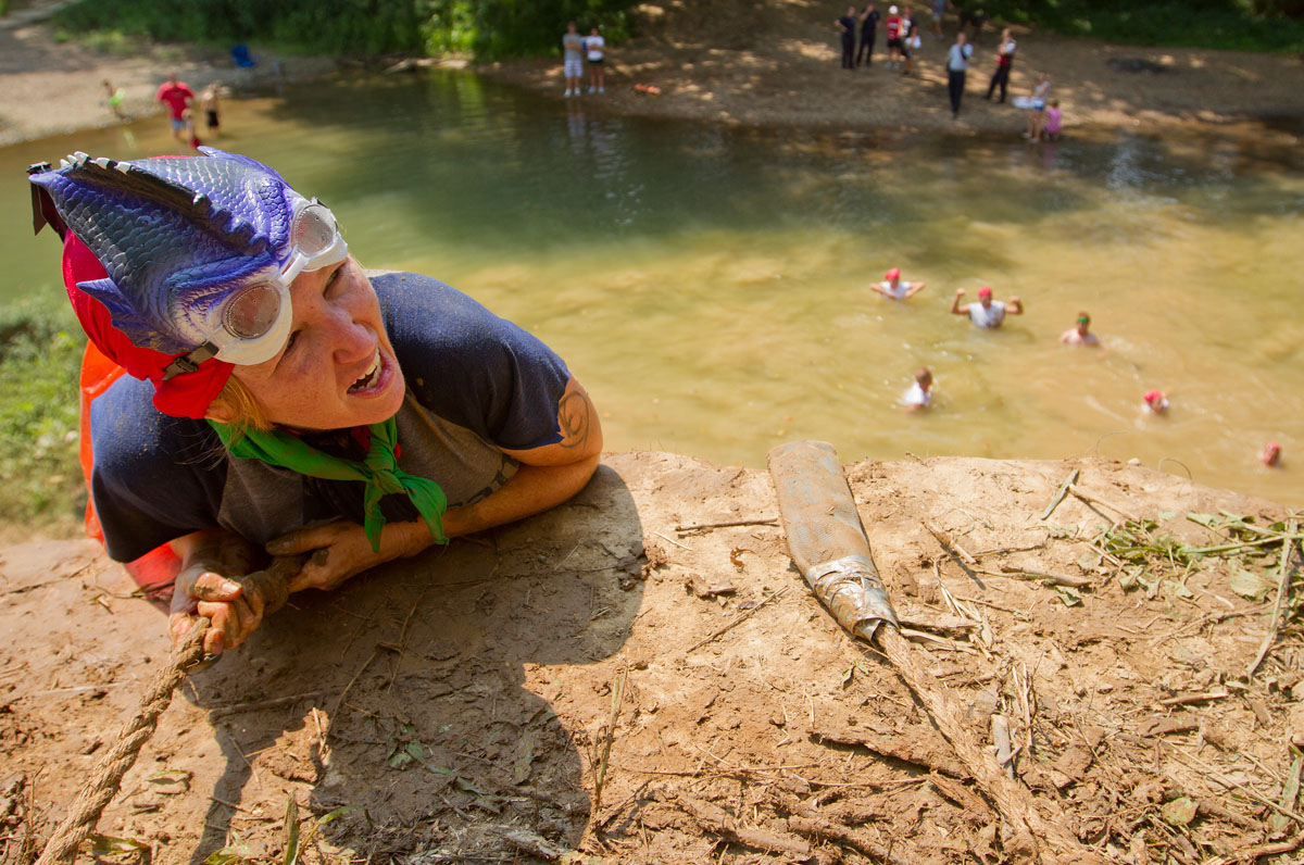 A competitor climbs a cliff during the  BG Gauntlet, the first annual mud run held to benefit the Family Enrichment Center Aug. 25, 2012, at Phil Moore Park in Bowling Green.